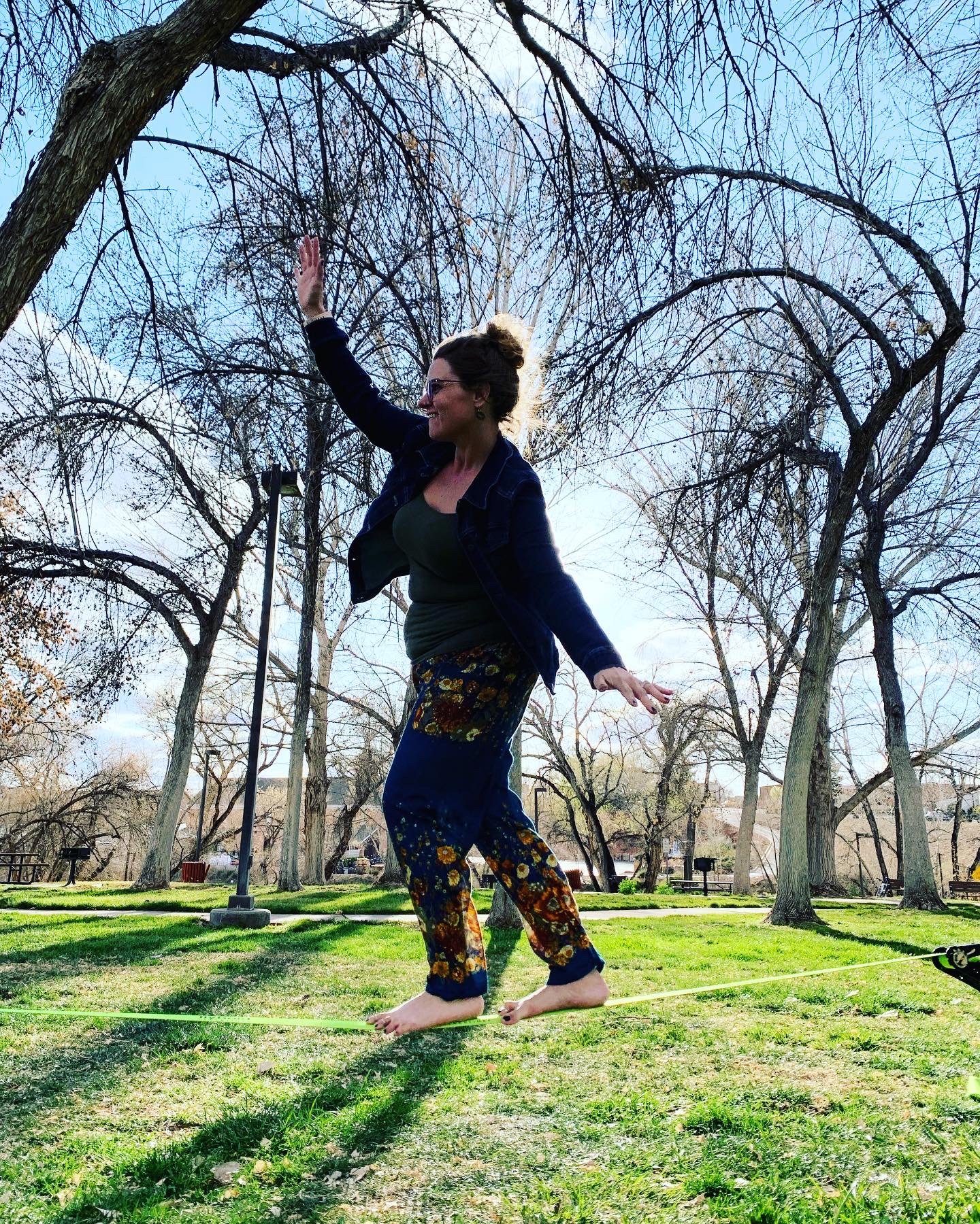 Alana slacklining in a park