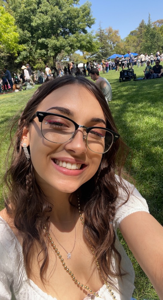 AndRea poses for a selfie in a crowded park