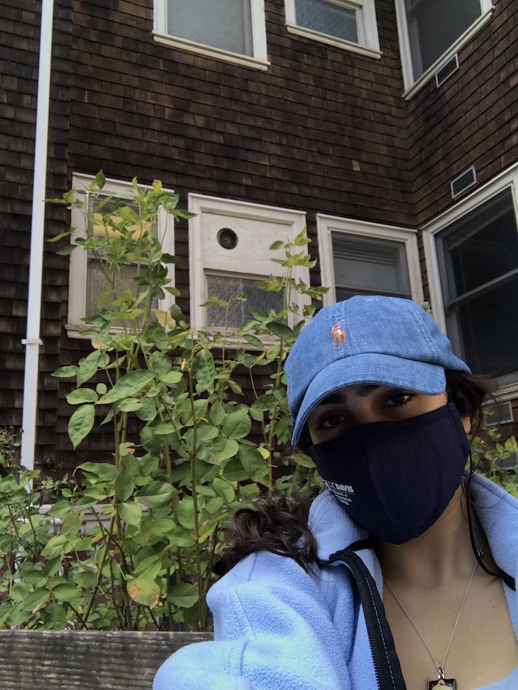 Person in a cap and face mask posing for a selfie