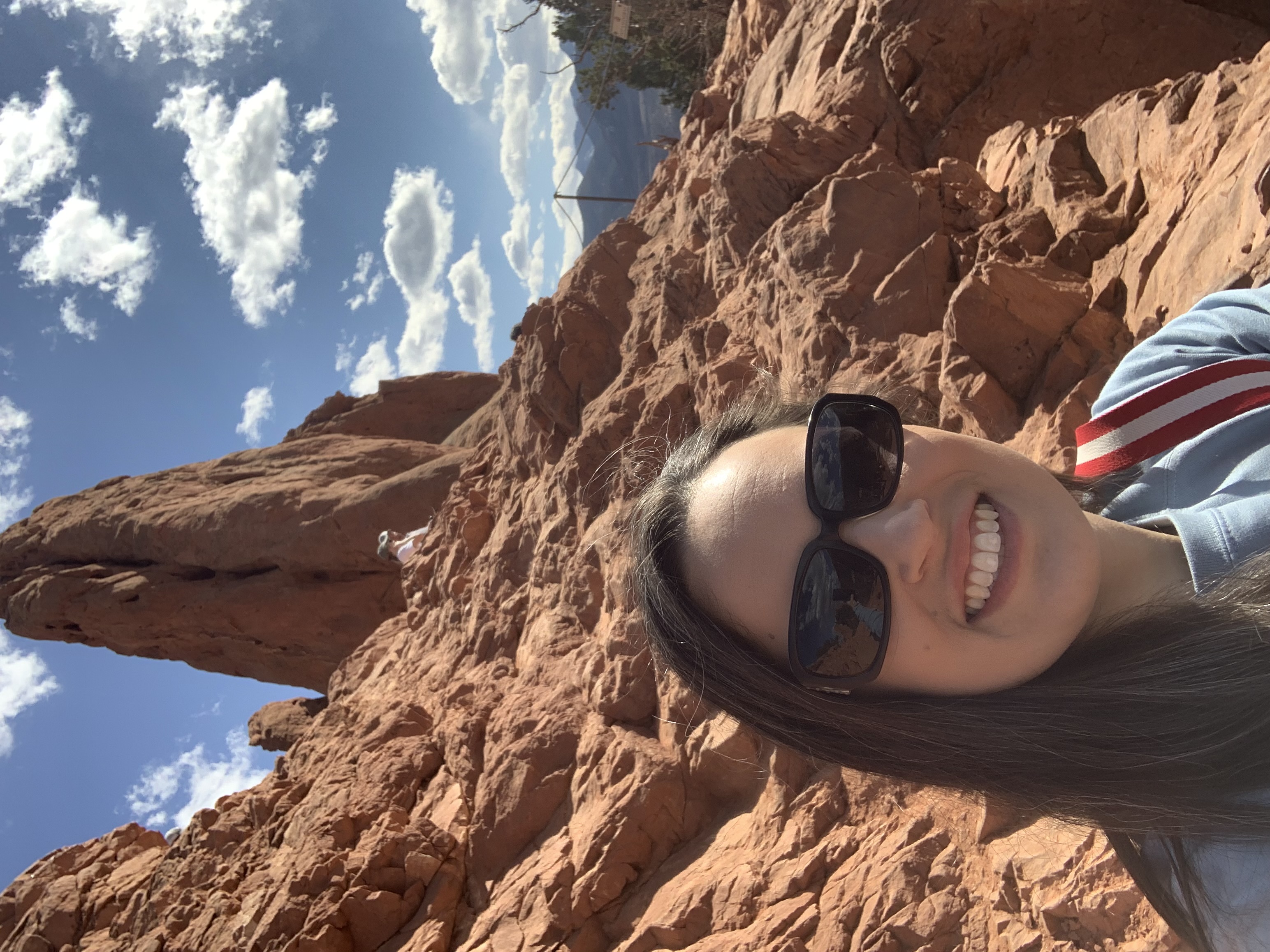 Caitlin in front of a reddish, rocky landscape