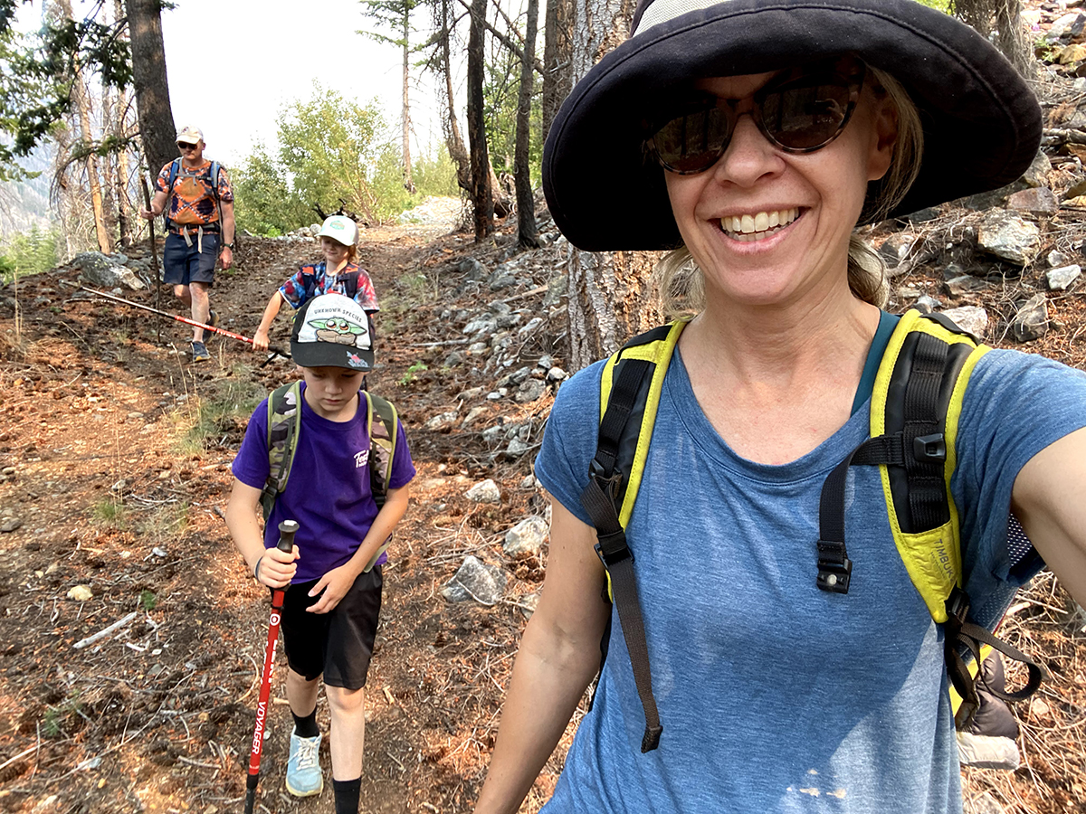 Laura and three other people hiking through a wooded area