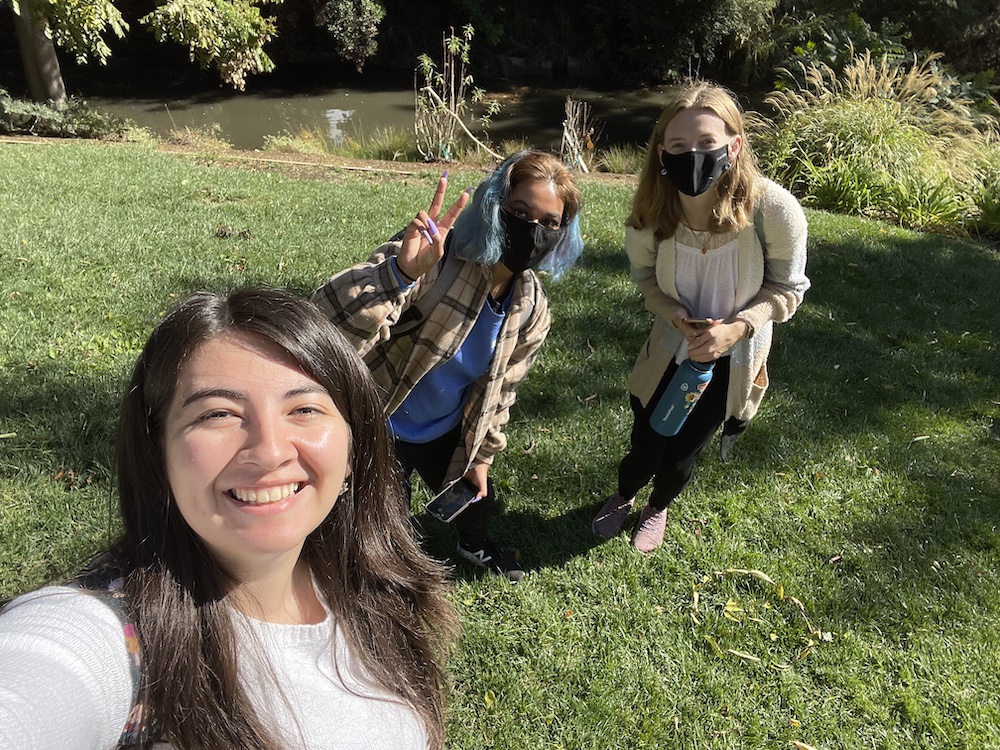 Julissa and two others pose for a selfie near a waterway
