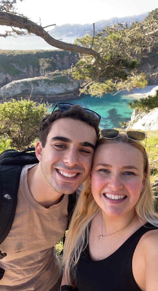 Two people pose for a selfie in nature