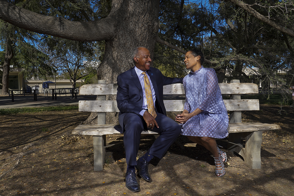 Chancellor Gary May and LeShelle May on a bench outside