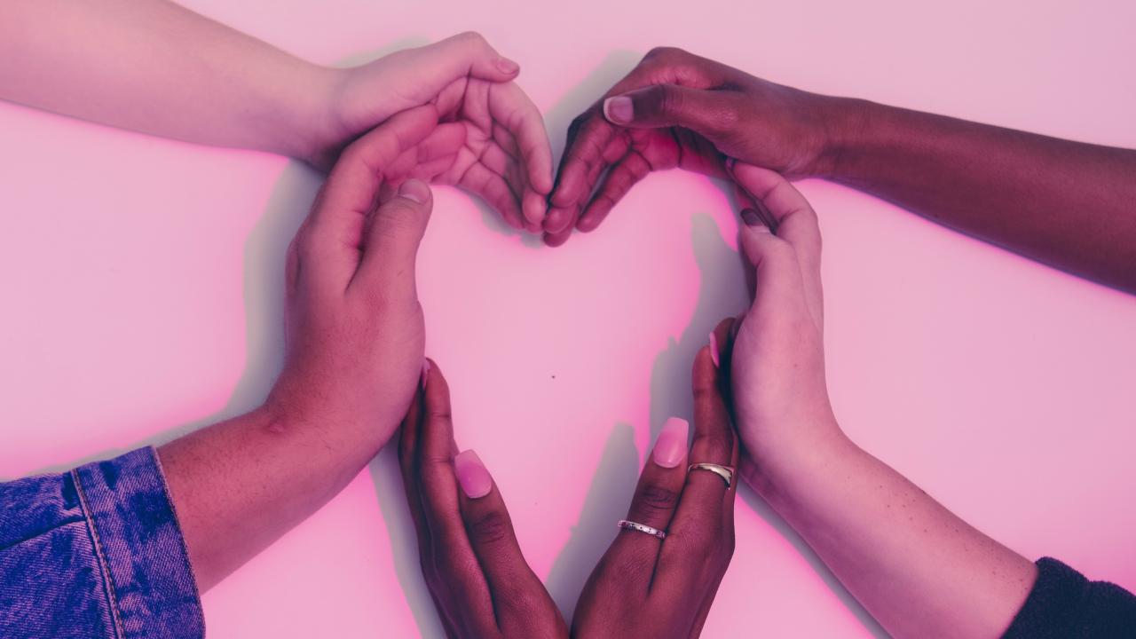 image of peoples' hands coming together to form a heart shape