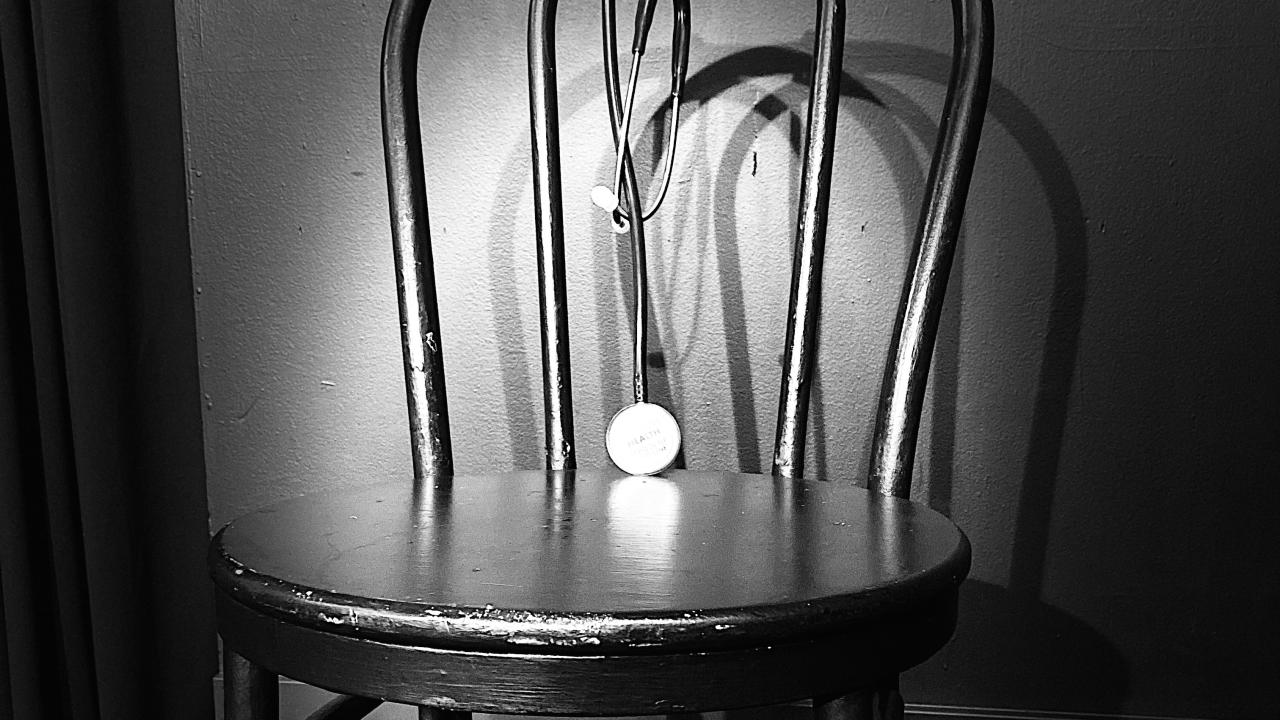 Black and white picture of chair with spotlight