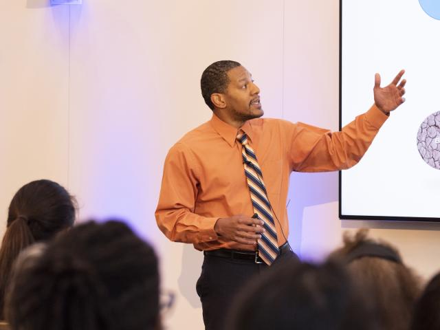 Man presenting powerpoint slide to audience