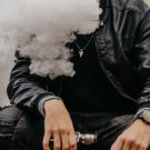 young man using a vape e-cigarette
