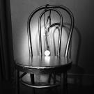 Black and white picture of chair with spotlight