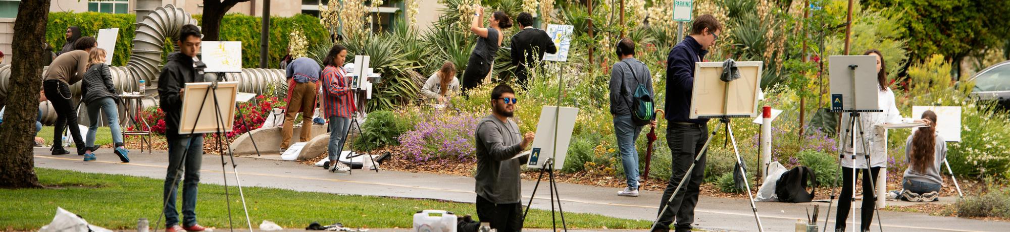 Image of students on the UC Davis campus painting en plein air.